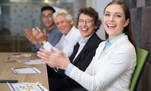 Women-clapping-in-a-boardroom-celebrating-success